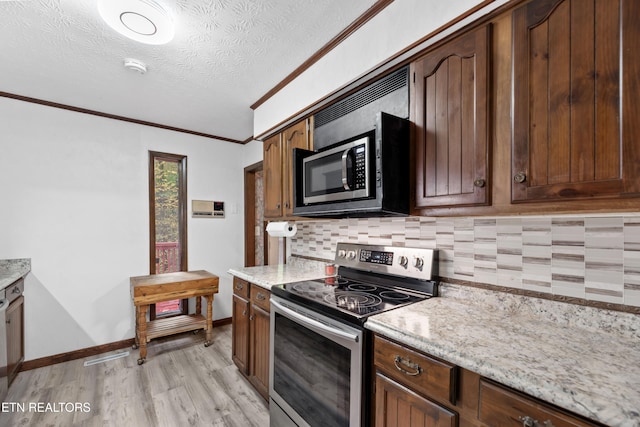 kitchen with tasteful backsplash, appliances with stainless steel finishes, a textured ceiling, crown molding, and light hardwood / wood-style flooring