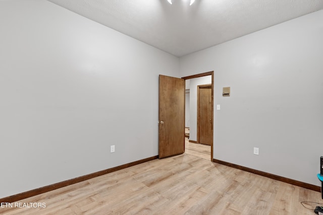 unfurnished room with light wood-type flooring