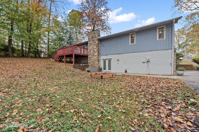 back of house with a wooden deck