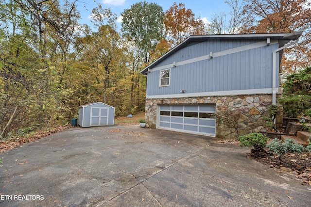 view of property exterior featuring a storage shed and a garage