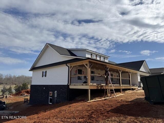 back of property with covered porch