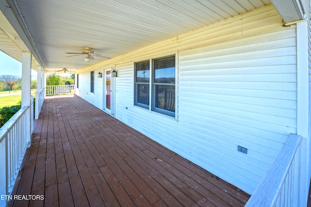 wooden terrace featuring a porch and ceiling fan