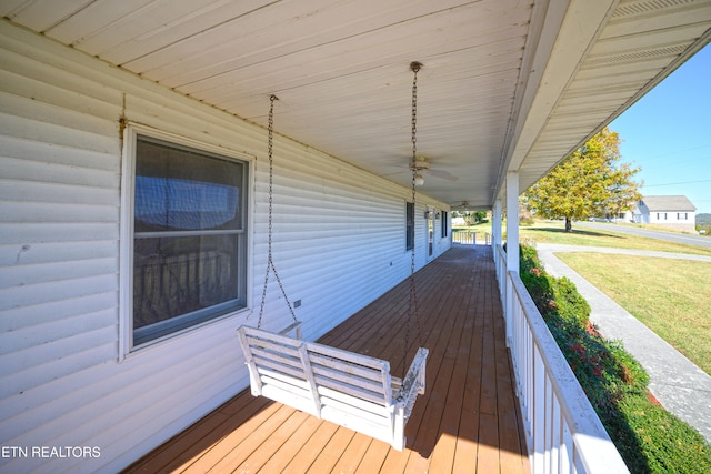 wooden deck featuring a yard and covered porch