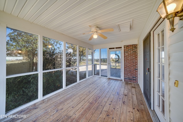 unfurnished sunroom with ceiling fan