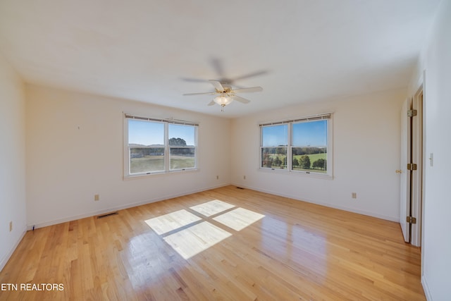 empty room featuring light hardwood / wood-style floors and ceiling fan