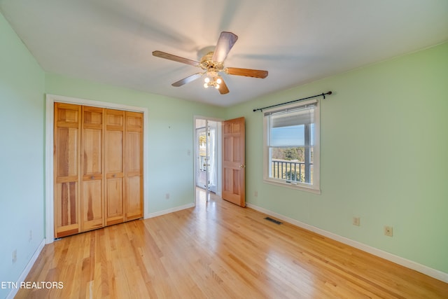 unfurnished bedroom featuring light hardwood / wood-style flooring, a closet, and ceiling fan