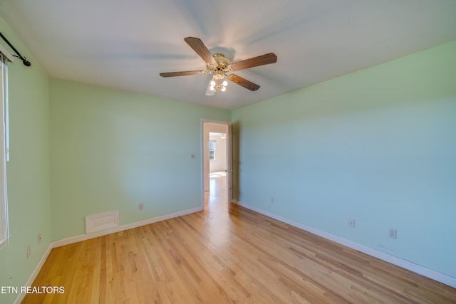 spare room featuring ceiling fan and light hardwood / wood-style flooring