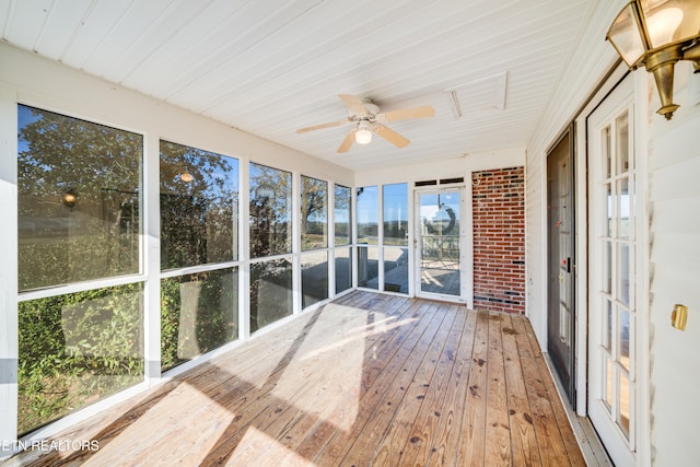 unfurnished sunroom with plenty of natural light and ceiling fan