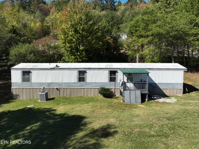 exterior space with cooling unit and a lawn