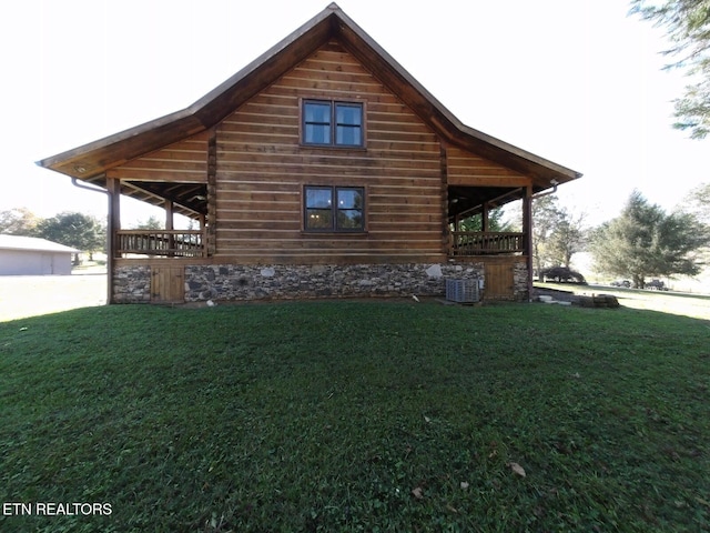 view of side of home with a yard, a garage, and central AC unit