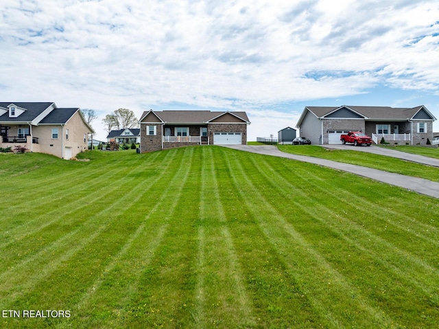 view of front of house featuring a garage and a front lawn