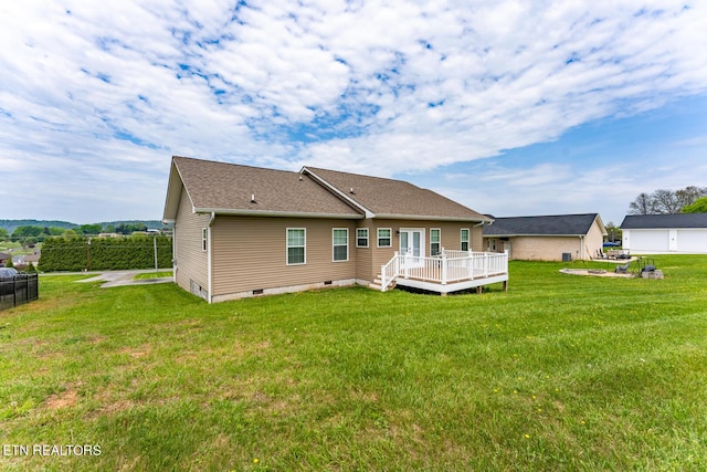 back of house with a lawn and a deck