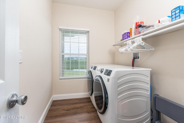 laundry area with dark hardwood / wood-style flooring and washer and clothes dryer