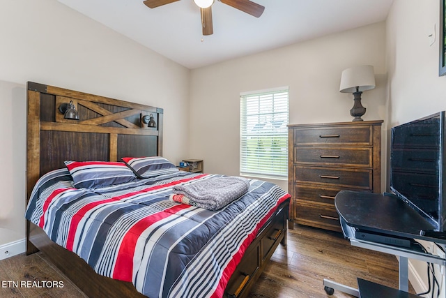 bedroom with dark hardwood / wood-style floors and ceiling fan