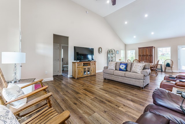 living room featuring ceiling fan, high vaulted ceiling, and dark hardwood / wood-style floors