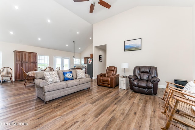 living room with french doors, hardwood / wood-style flooring, high vaulted ceiling, and ceiling fan