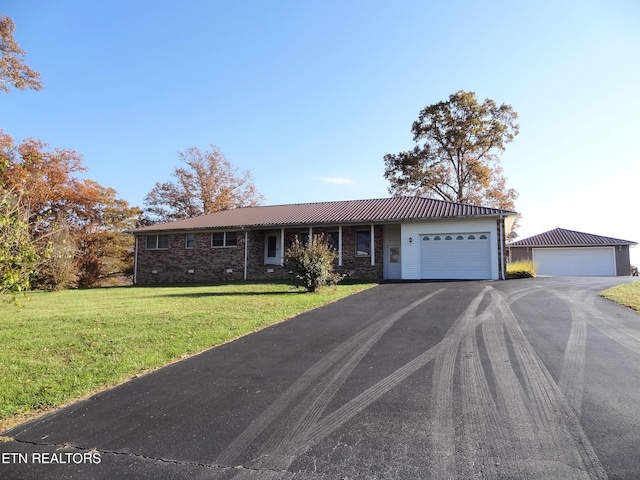 single story home featuring a front lawn and a garage