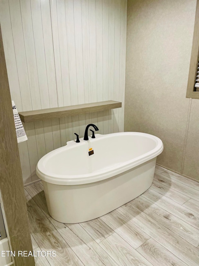 bathroom featuring a tub and wood-type flooring