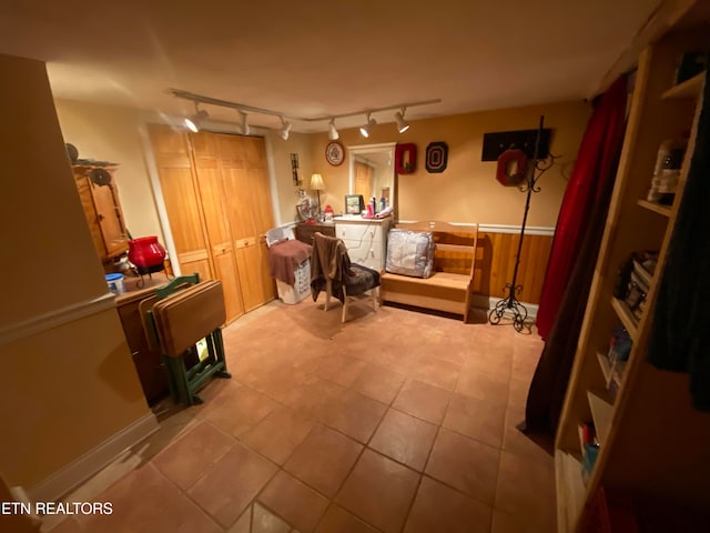 interior space featuring a wainscoted wall and tile patterned flooring