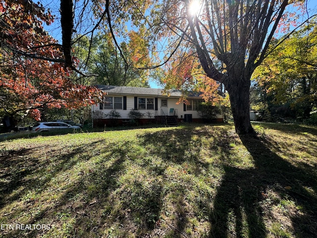 ranch-style home with a front yard