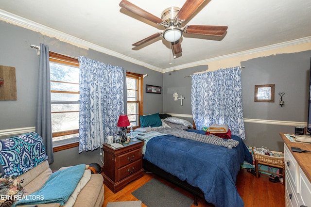 bedroom featuring a ceiling fan, wood finished floors, and crown molding