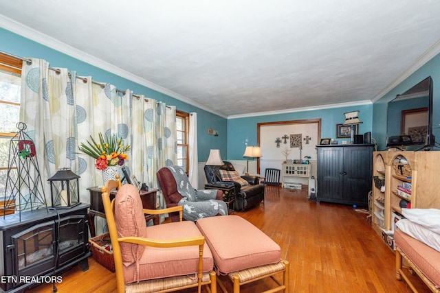 living area with wood finished floors, radiator heating unit, and ornamental molding