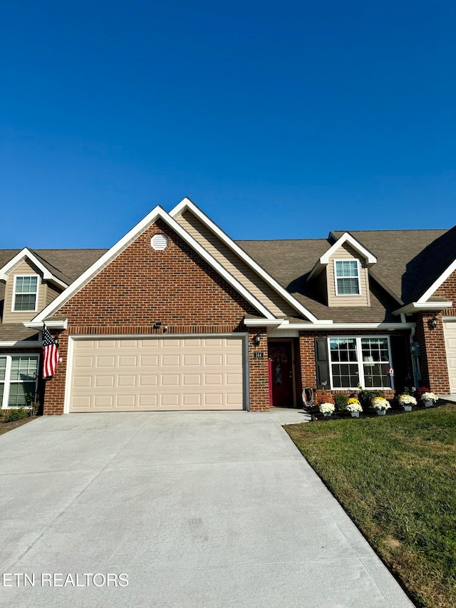 view of front of home featuring a front yard and a garage