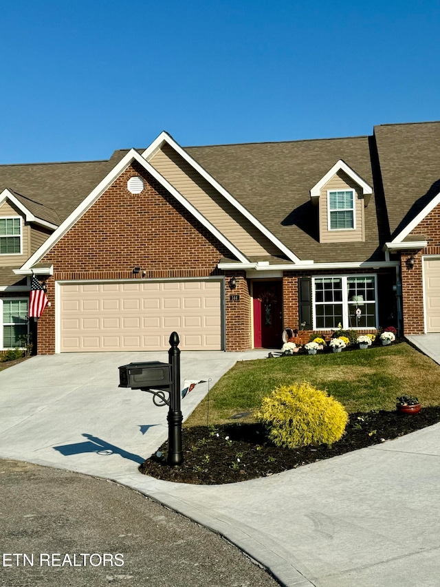 view of front of home with a front lawn and a garage