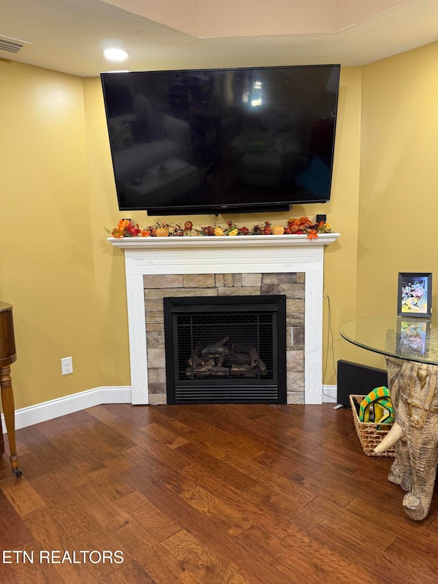 room details with hardwood / wood-style flooring and a tile fireplace