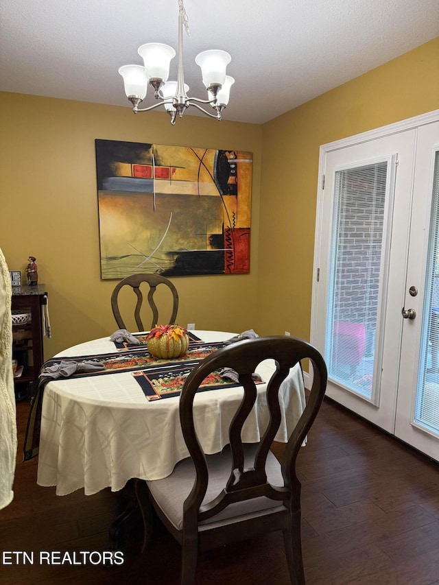 dining area featuring an inviting chandelier and dark hardwood / wood-style floors