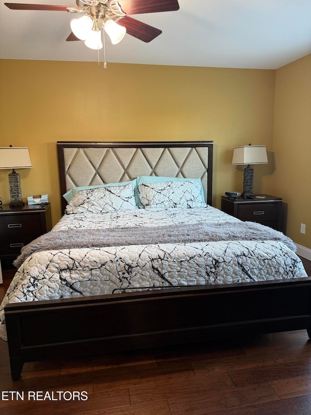 bedroom with dark wood-type flooring and ceiling fan