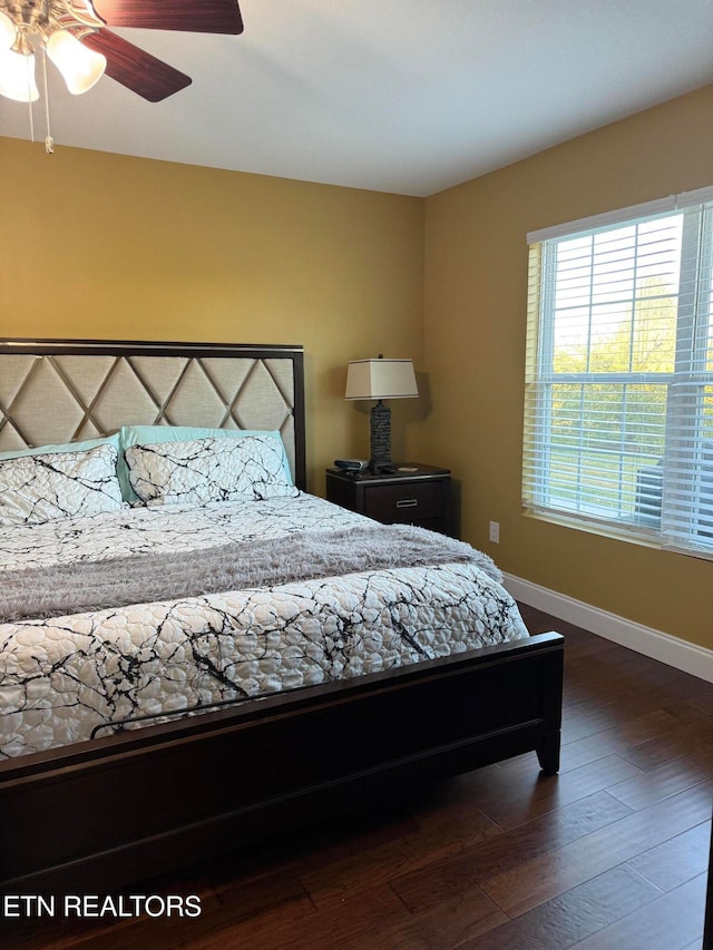 bedroom with dark wood-type flooring and ceiling fan