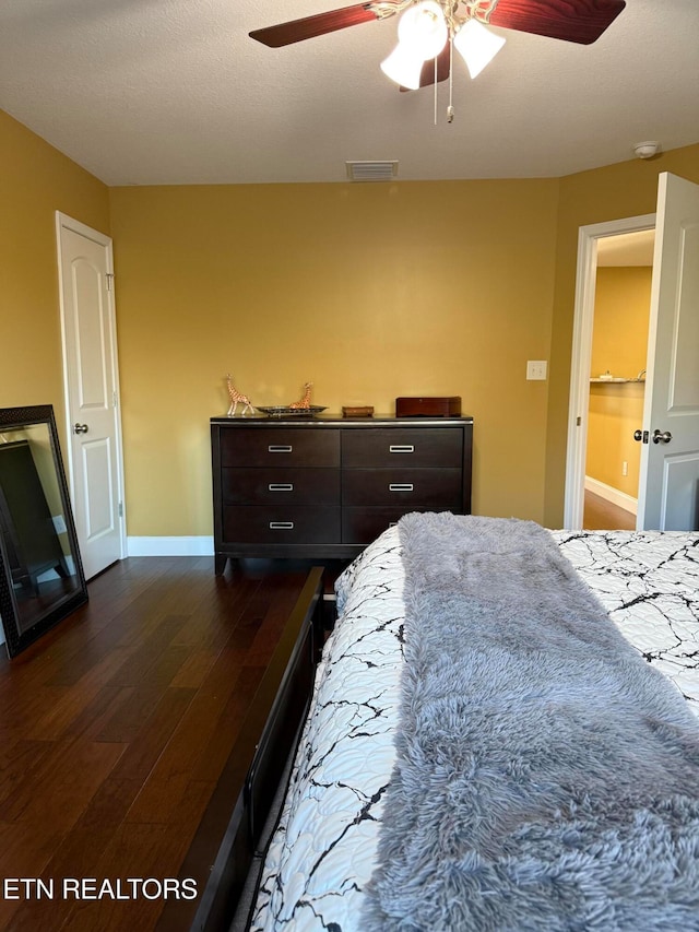 bedroom with dark wood-type flooring and ceiling fan