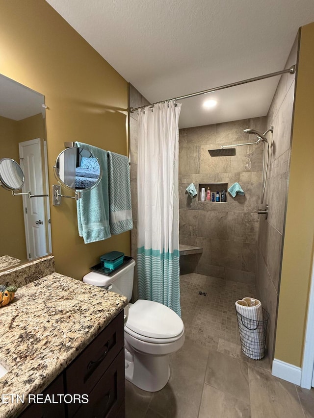 bathroom featuring a textured ceiling, a shower with shower curtain, toilet, tile patterned floors, and vanity