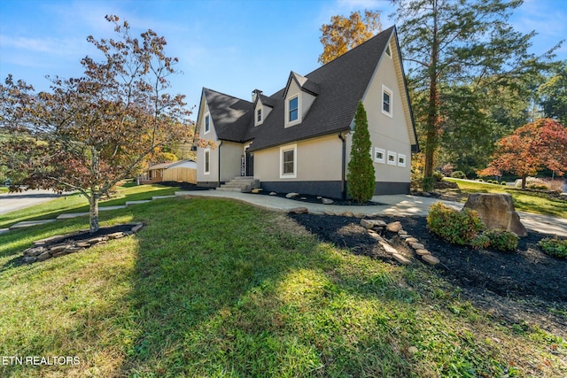 view of side of home with a garage and a lawn