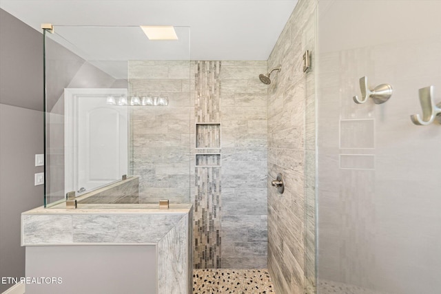 bathroom with tiled shower