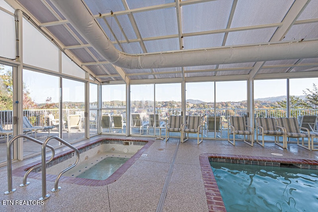 view of pool with a mountain view and an indoor in ground hot tub