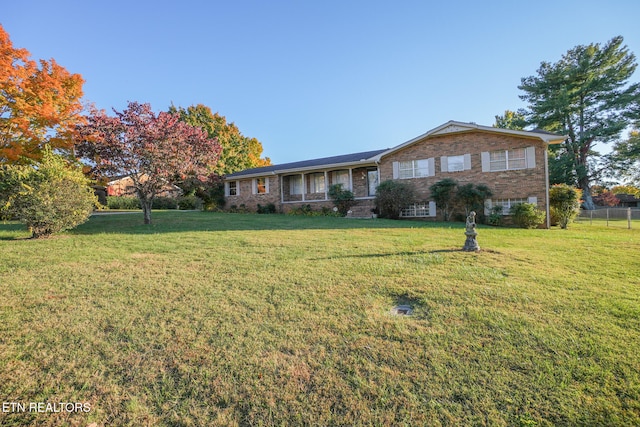 ranch-style home featuring a front yard