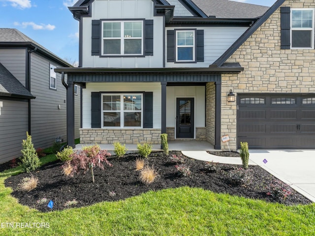 view of front of home with a porch and a garage