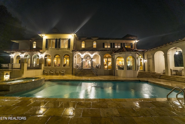 8719 Inlet Dr, Knoxville, TN 37922 - pool at twilight with a patio area, french doors, and a pool with connected hot tub