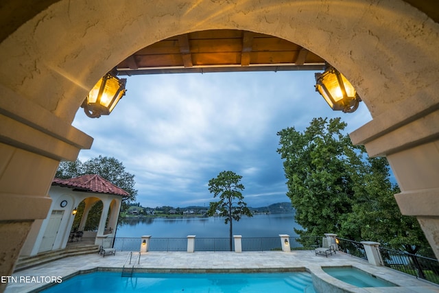 8719 Inlet Dr, Knoxville, TN 37922 - view of swimming pool featuring a patio, a water view, and a pool with connected hot tub
