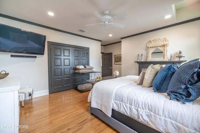 bedroom with crown molding, light hardwood / wood-style flooring, and ceiling fan