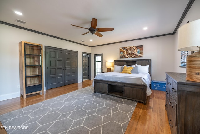 bedroom featuring dark hardwood / wood-style flooring, multiple windows, a closet, and ceiling fan