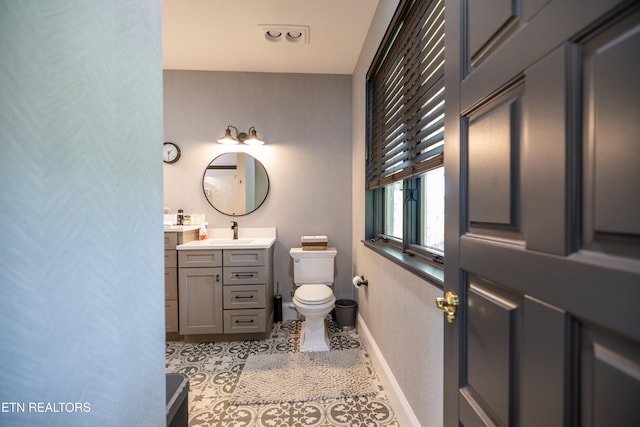 bathroom featuring vanity, toilet, and tile patterned floors