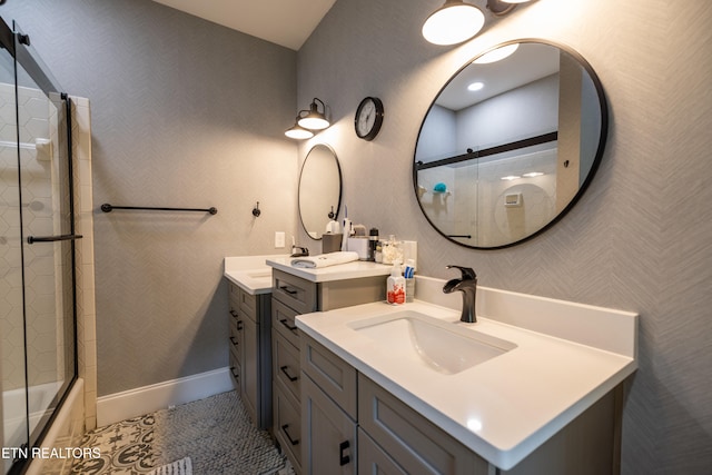 bathroom featuring vanity, shower / bath combination with glass door, and tile patterned flooring