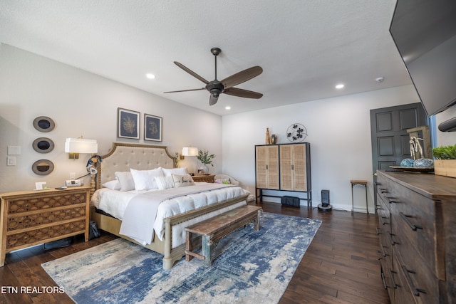 bedroom featuring dark wood-type flooring, a textured ceiling, and ceiling fan