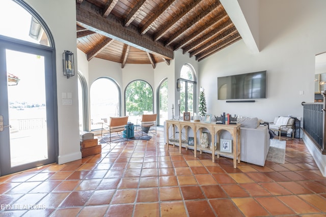 living room with beamed ceiling, wood ceiling, and plenty of natural light