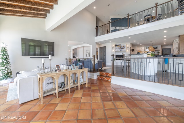 tiled living room with a high ceiling