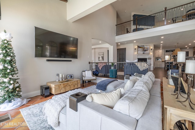 8719 Inlet Dr, Knoxville, TN 37922 - tiled living area featuring a towering ceiling, arched walkways, a fireplace, baseboards, and recessed lighting