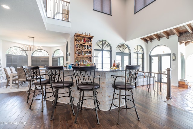 8719 Inlet Dr, Knoxville, TN 37922 - indoor bar with a towering ceiling, dark wood finished floors, healthy amount of natural light, beamed ceiling, and pendant lighting
